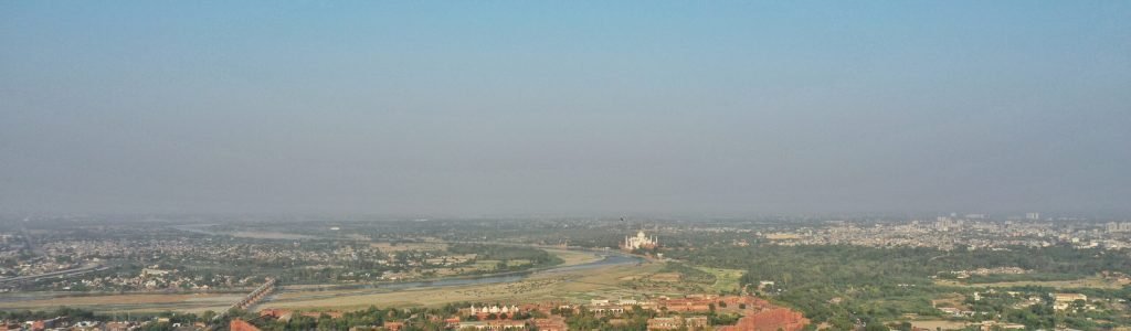 An aerial shot of Agra city with Taj-Mahal on the background